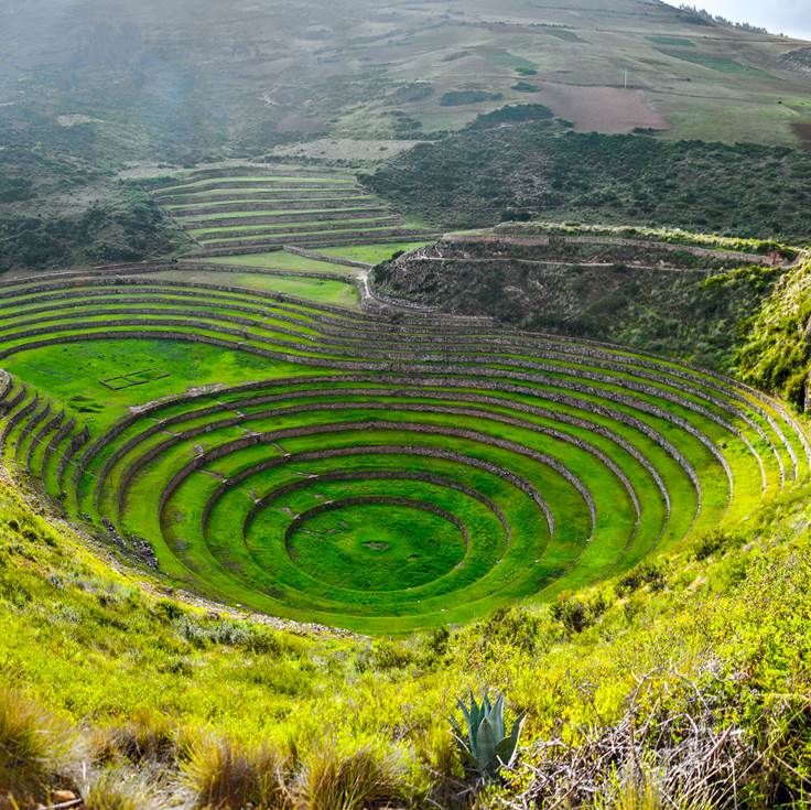 Circular agricultural terraces at Moray surrounded by mountains, inviting travelers to explore the Sacred Valley – Ali Peru Treks