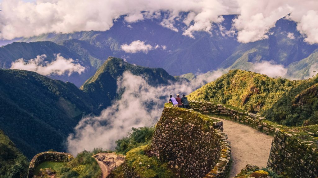 Hikers celebrating the view from Inti Punku, the final inca trail archaeological sites reward - Ali Peru Treks