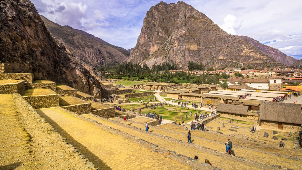 A panoramic view of the vast Inca agricultural and defensive terraces and stone structures of the Ollantaytambo Ruins, recognized as one of the essential things to do Cusco. - Ali Peru Treks