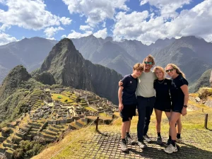 Family celebrating arrival at Machu Picchu after completing the Classic Inca Trail 4-Day Hike