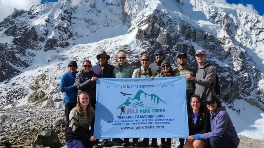 Happy hikers celebrate reaching the high Salkantay Pass with Ali Perú Treks after proper acclimatization.