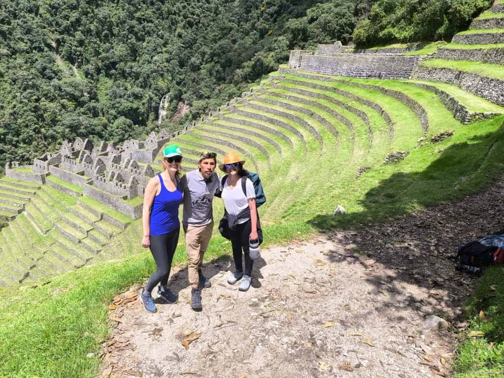 Hikers and guide overlooking Wiñay Wayna ruins during an inca trail tour