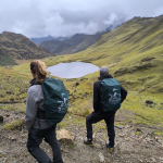 Hikers enjoying a panoramic view of a lagoon during the Lares Trek in Peru