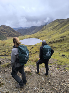 Hikers enjoying a panoramic view of a lagoon during the Lares Trek in Peru