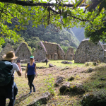 Hikers exploring Chachabamba archaeological site along the inca trail to machu picchu
