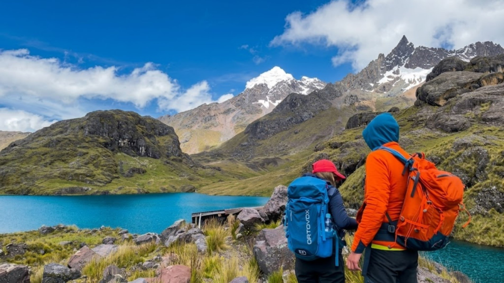 Hikers overlooking a stunning mountain lake on an Ausangate trek tour