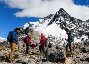 Hikers posing in front of snow-capped Salkantay, the highest peak in the Vilcabamba mountain range in Peru