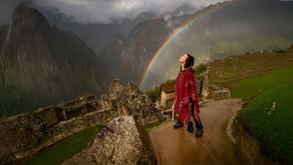 Tourist Admiring Rainbow at Machu Picchu
