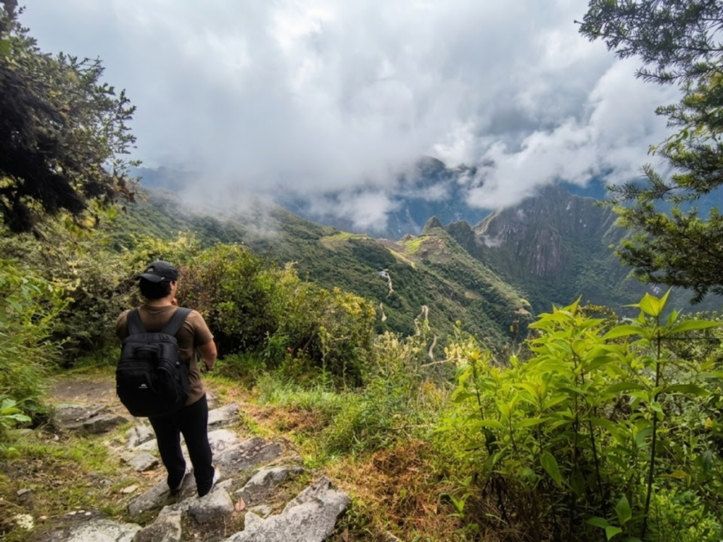 Inca trail hiker looking at machu picchu from the sun gate