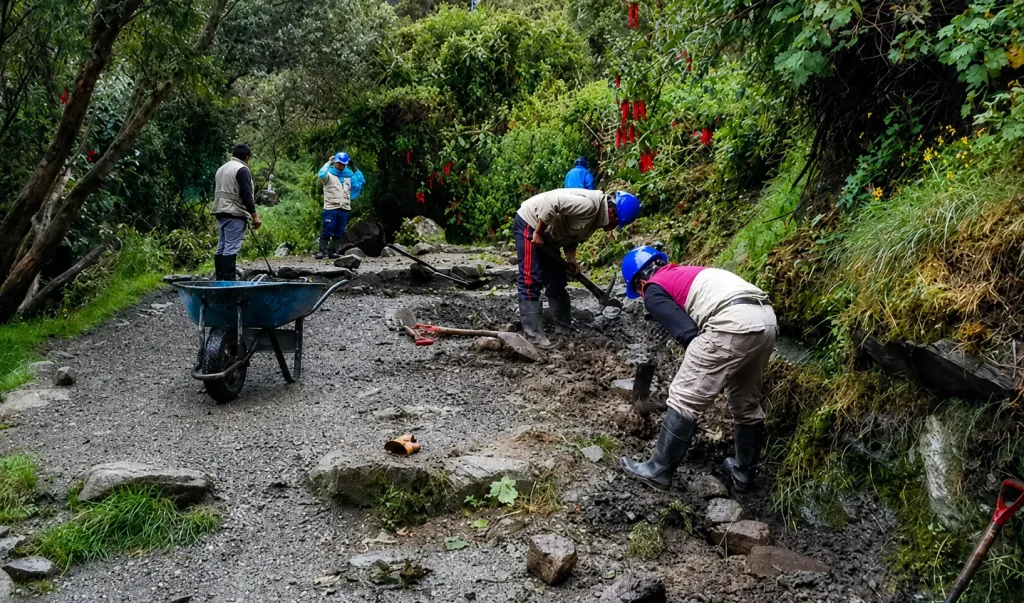 A group of workers performing maintenance and cleanup work on a trail in the Inca Trail Network